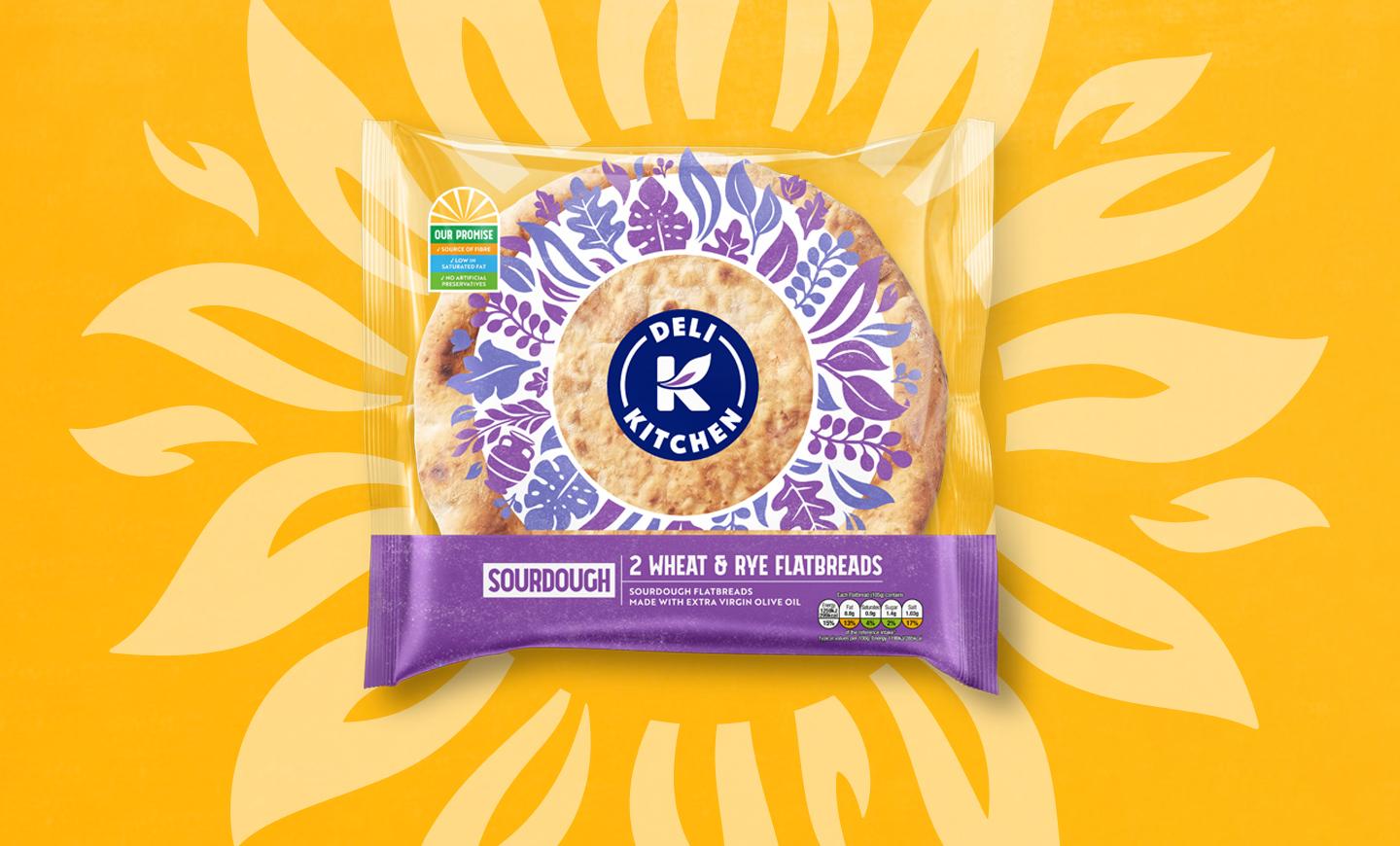 A Deli Kitchen sourdough wheat and rye flatbread pack against a yellow sunburst background