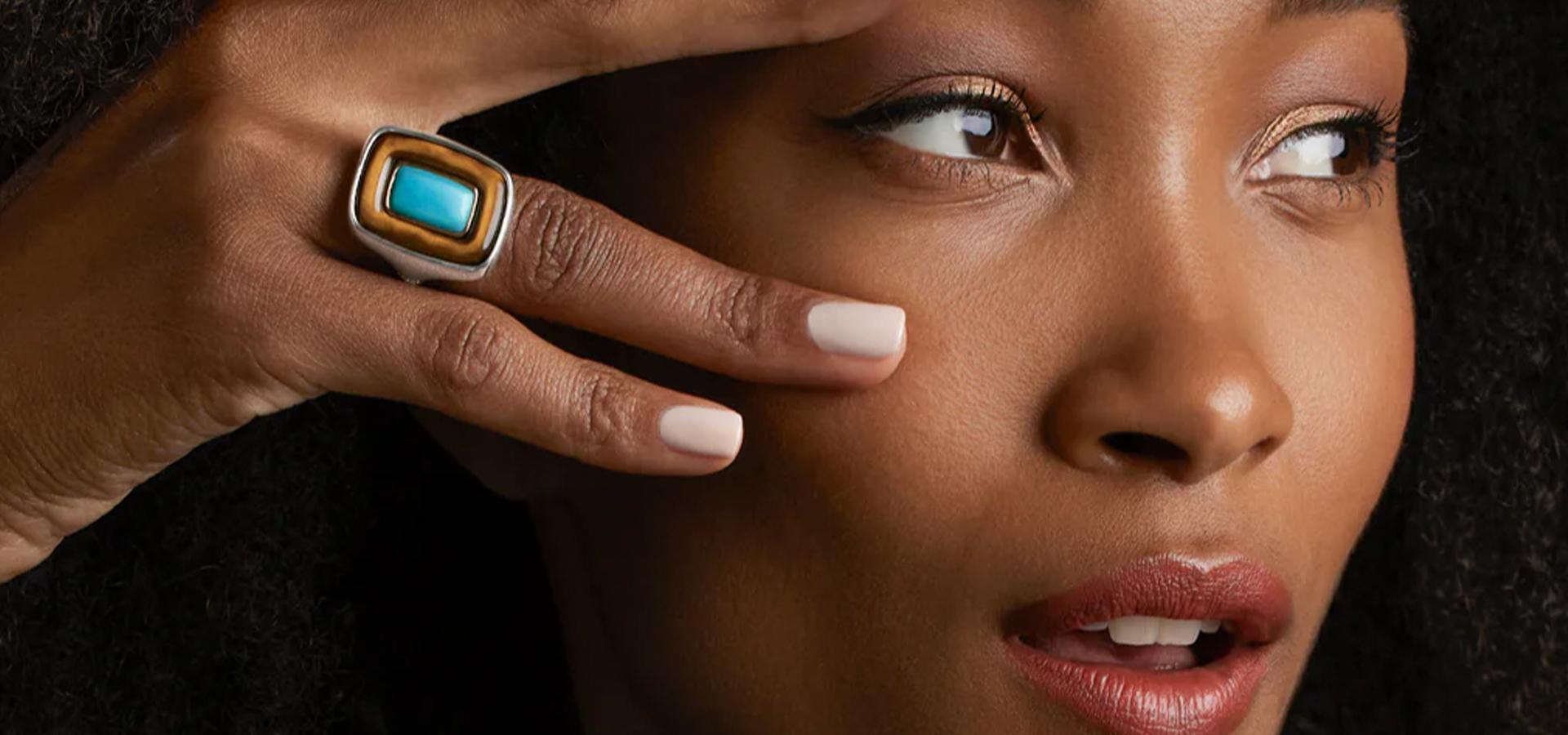 Close-up of a woman wearing a turquoise statement ring
