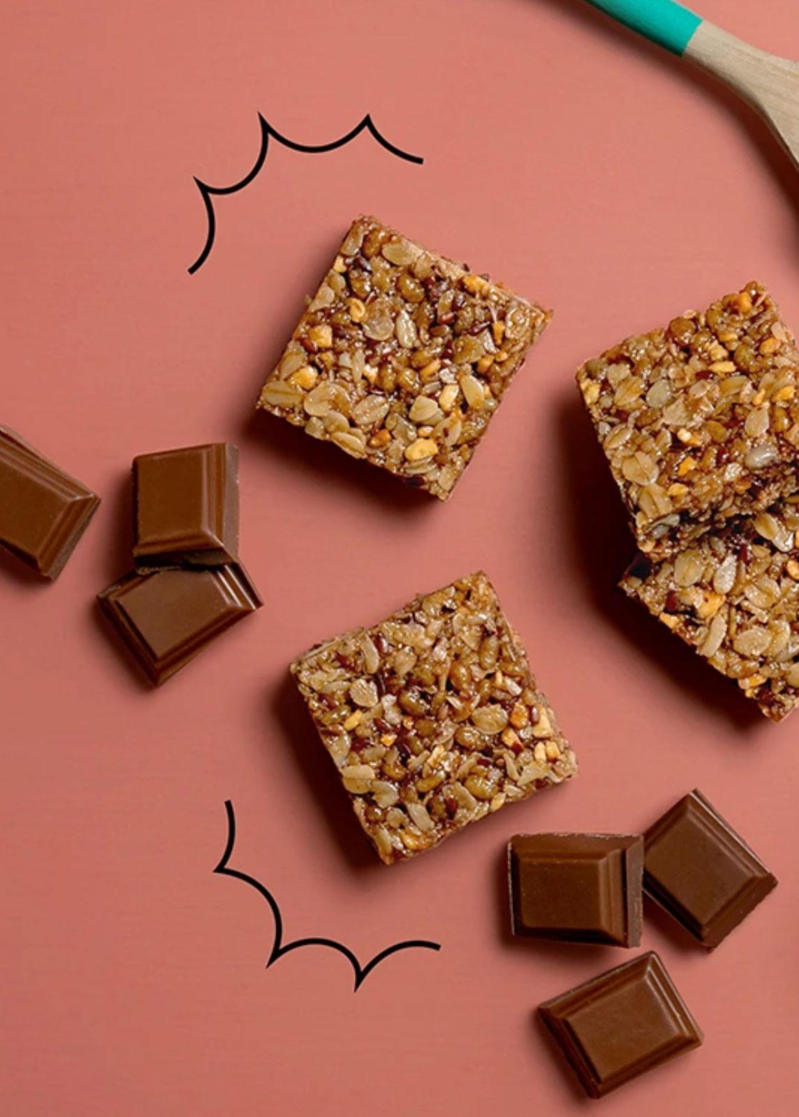 Graze flapjack squares and chocolate pieces on a pink background