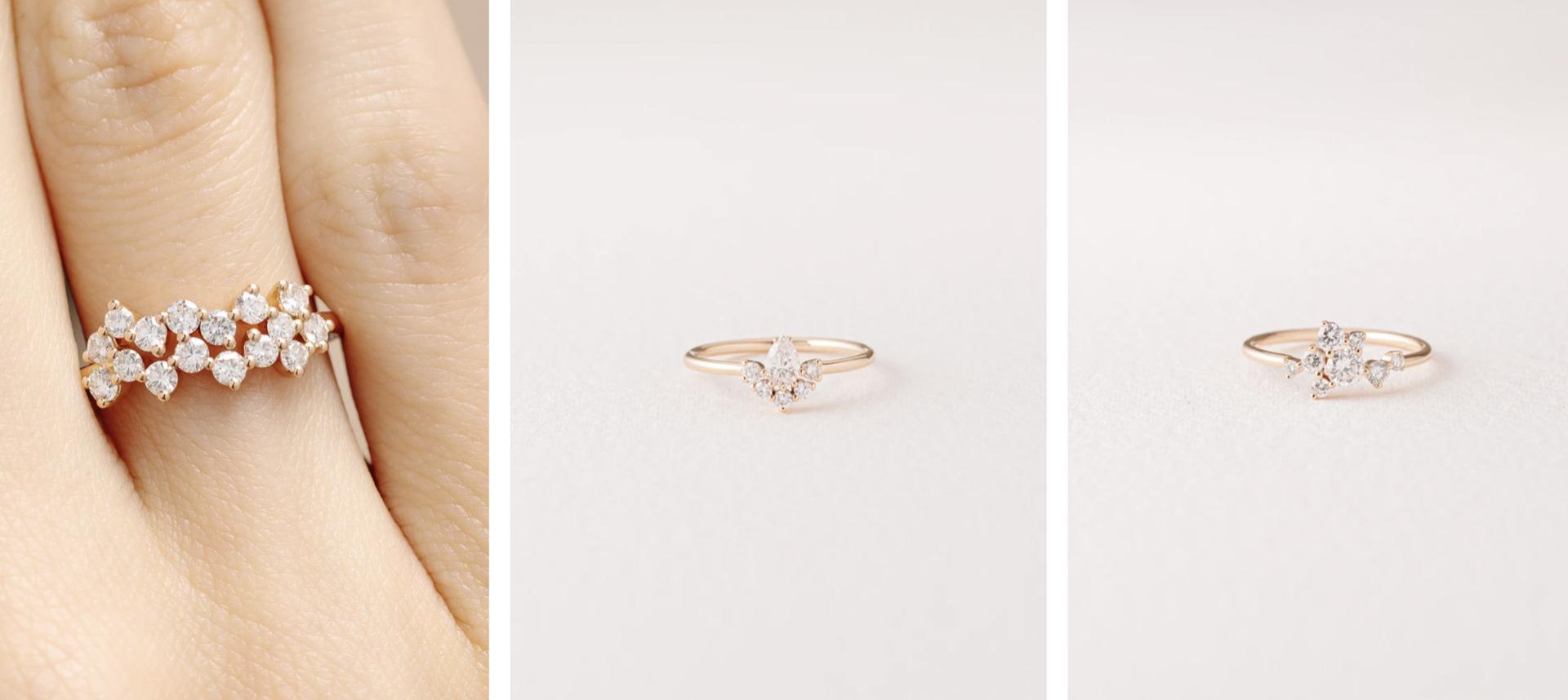 A cluster diamond ring worn on a finger, beside two single diamond rings