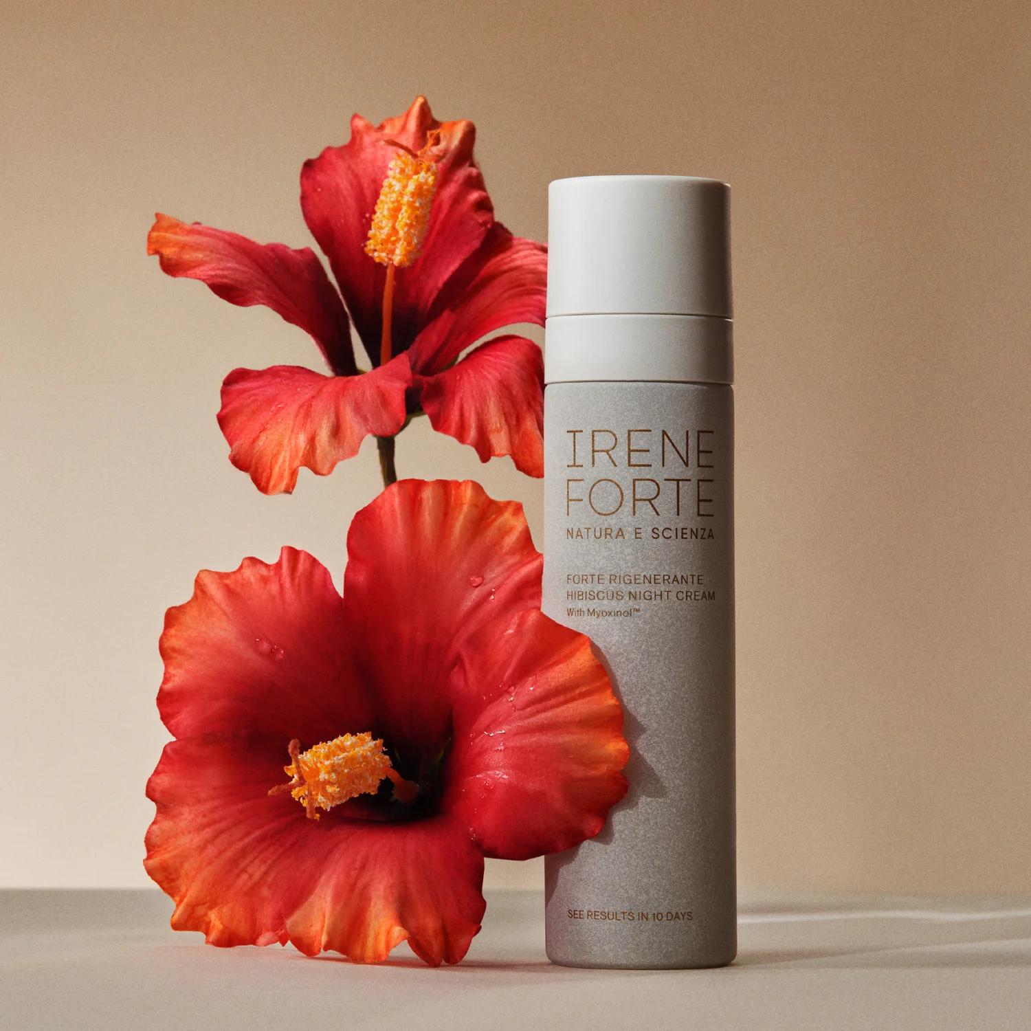 An Irene Forte Hibiscus night cream bottle with red hibiscus flowers