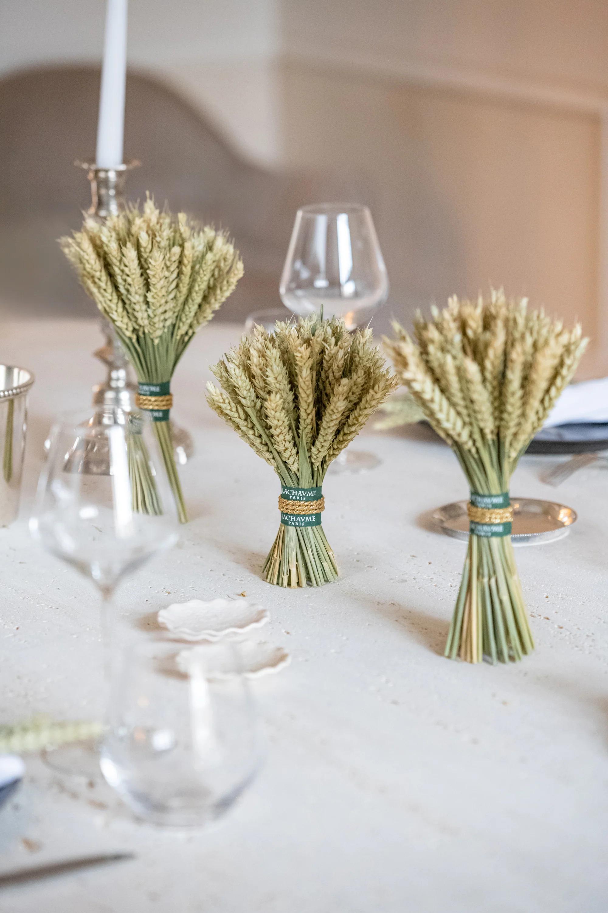 Lachaume wheat sheaf bouquets on a set dining table