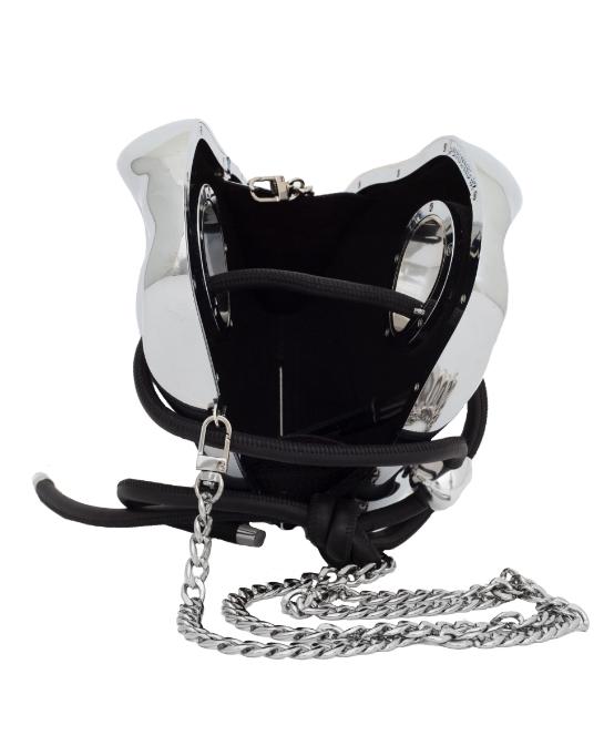 A silver Published By bag with a black strap and a chain